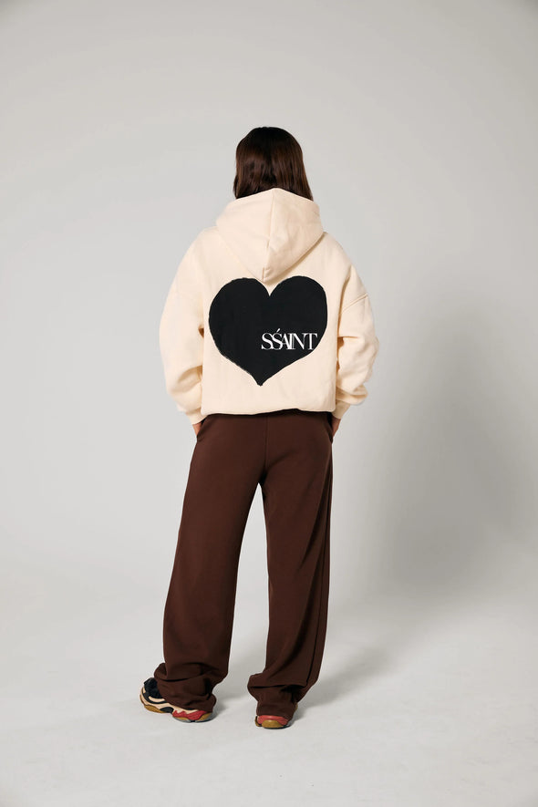 Elevate your off-duty style with the SŚAINT Butter Hoodie – where comfort meets bold design. Crafted from a soft and durable 50% cotton, 50% polyester blend, this fleece-lined hoodie is the perfect throw-on for cooler days.