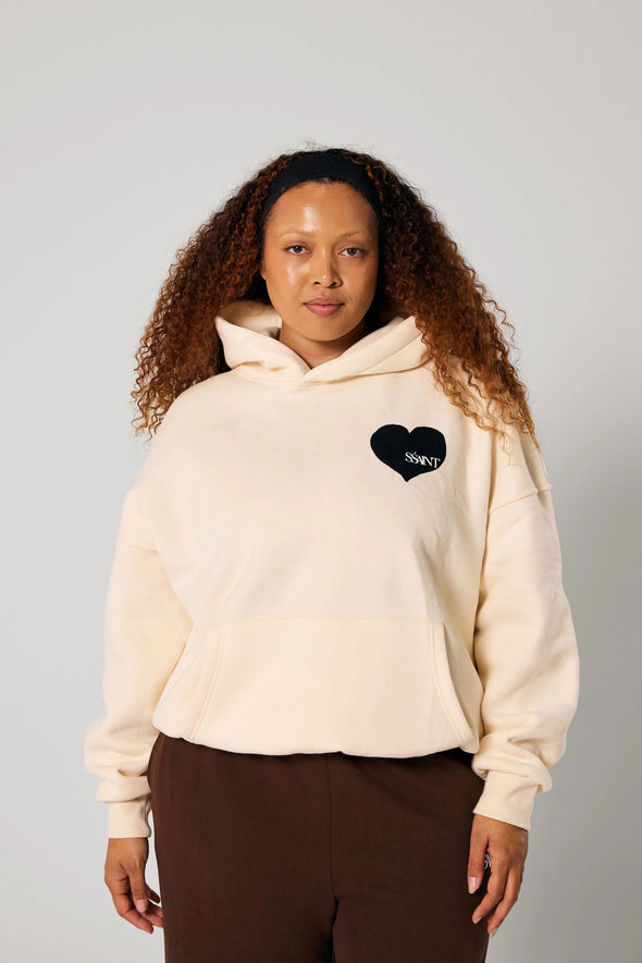 Elevate your off-duty style with the SŚAINT Butter Hoodie – where comfort meets bold design. Crafted from a soft and durable 50% cotton, 50% polyester blend, this fleece-lined hoodie is the perfect throw-on for cooler days.