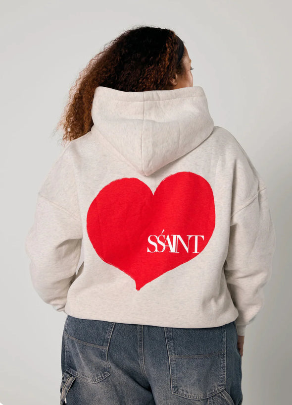Elevate your off-duty style with the SŚAINT Grey Heart Hoodie – where comfort meets bold design. Crafted from a soft and durable 50% cotton, 50% polyester blend, this fleece-lined hoodie is the perfect throw-on for cooler days.