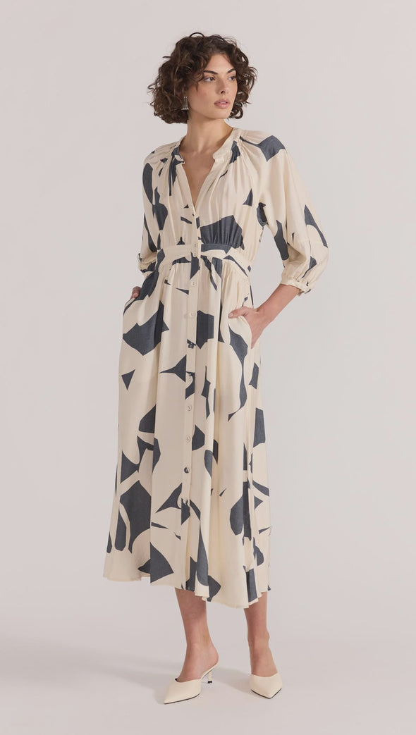 Introducing the Aura Midi Dress - the perfect combination of style and ease. Cut from a lightweight fabric in our exclusive abstract print, this dress effortlessly transitions from casual days to special occasions. With a button-through front, gathered waist, and soft sleeve volume, it's the epitome of throw-on-and-wow.