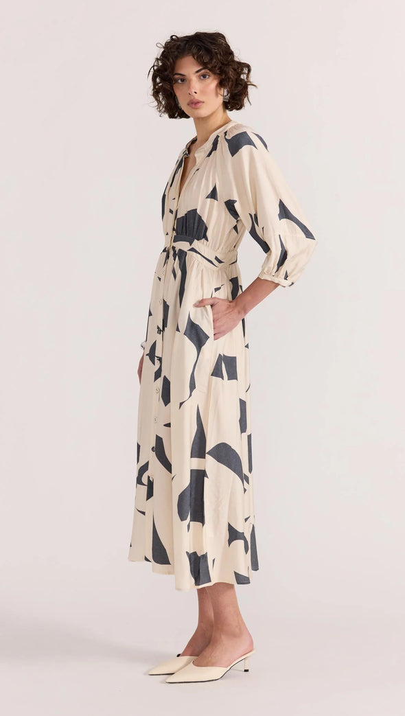 Introducing the Aura Midi Dress - the perfect combination of style and ease. Cut from a lightweight fabric in our exclusive abstract print, this dress effortlessly transitions from casual days to special occasions. With a button-through front, gathered waist, and soft sleeve volume, it's the epitome of throw-on-and-wow.