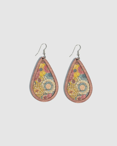 Hook earrings with a wooden teardrop with blue and yellow floral design.