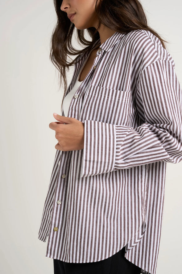 Effortlessly elevate your style with our fresh take on a classic button-up. The modern chocolate and white pinstripes add a touch of sophistication, while the lightweight fabric keeps you comfortable. Whether worn loose or tucked in, this versatile shirt is perfect for both polished office wear and casual weekends.