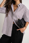 Effortlessly elevate your style with our fresh take on a classic button-up. The modern chocolate and white pinstripes add a touch of sophistication, while the lightweight fabric keeps you comfortable. Whether worn loose or tucked in, this versatile shirt is perfect for both polished office wear and casual weekends.