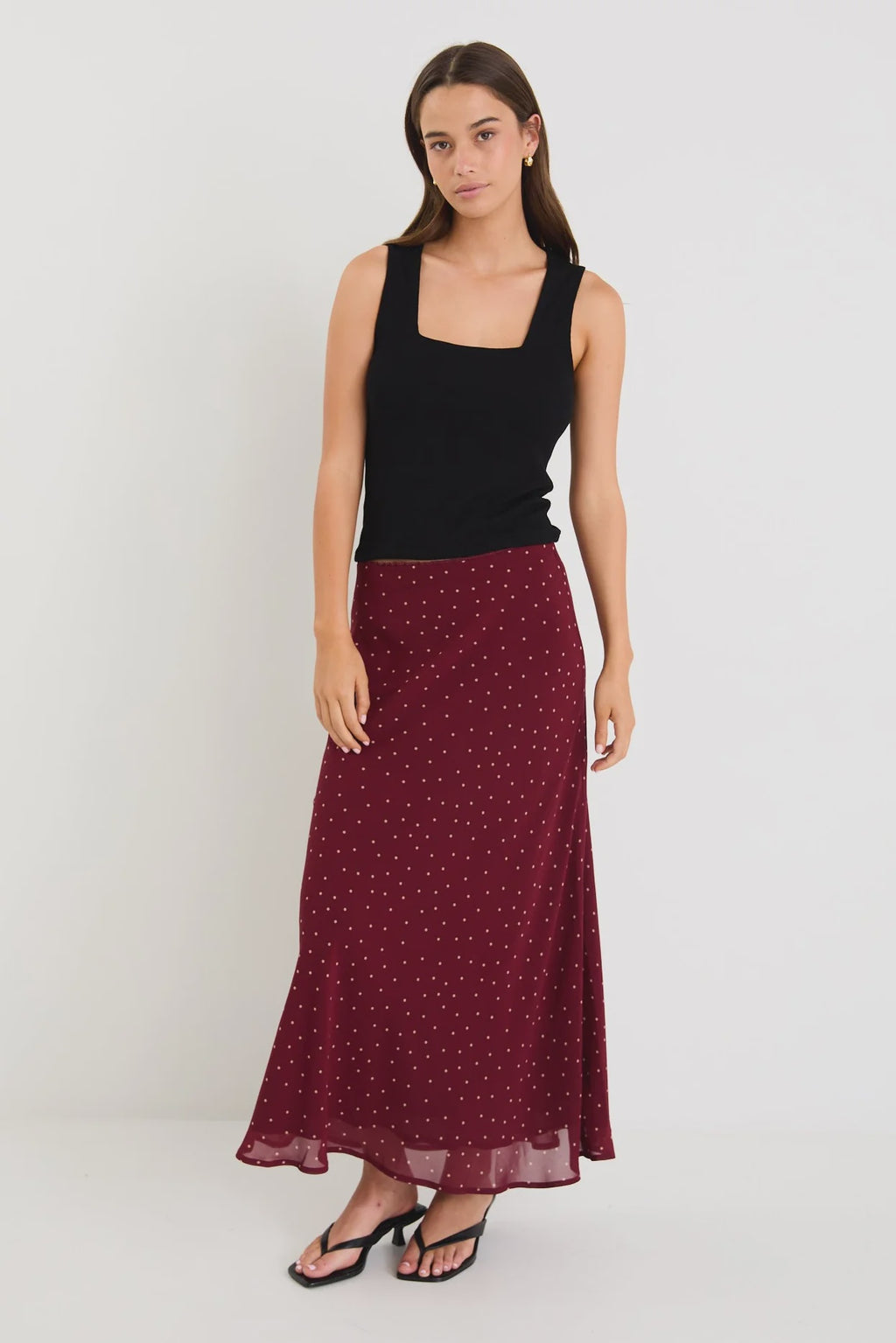Meet your new go-to: the Emporium Skirt. Crafted in luxurious satin that moves beautifully with you, this charming piece showcases a classic polka dot print that never goes out of style. The expertly cut bias silhouette skims the body gracefully, creating an effortlessly chic look whether you're dressing it up for a night out or keeping it casual with a simple tee. Light, fluid, and endlessly versatile, the Emporium Skirt is the kind of piece you'll reach for again and again.v