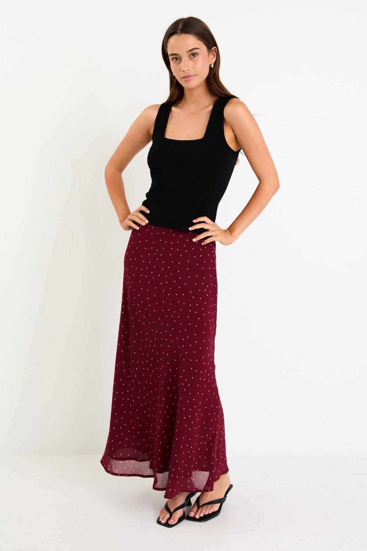 Meet your new go-to: the Emporium Skirt. Crafted in luxurious satin that moves beautifully with you, this charming piece showcases a classic polka dot print that never goes out of style. The expertly cut bias silhouette skims the body gracefully, creating an effortlessly chic look whether you're dressing it up for a night out or keeping it casual with a simple tee. Light, fluid, and endlessly versatile, the Emporium Skirt is the kind of piece you'll reach for again and again.