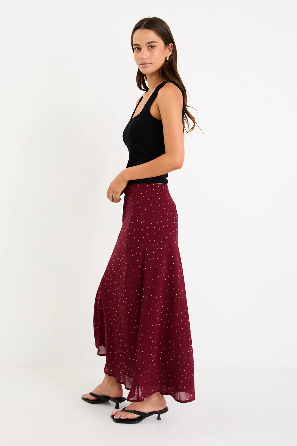 Meet your new go-to: the Emporium Skirt. Crafted in luxurious satin that moves beautifully with you, this charming piece showcases a classic polka dot print that never goes out of style. The expertly cut bias silhouette skims the body gracefully, creating an effortlessly chic look whether you're dressing it up for a night out or keeping it casual with a simple tee. Light, fluid, and endlessly versatile, the Emporium Skirt is the kind of piece you'll reach for again and again.