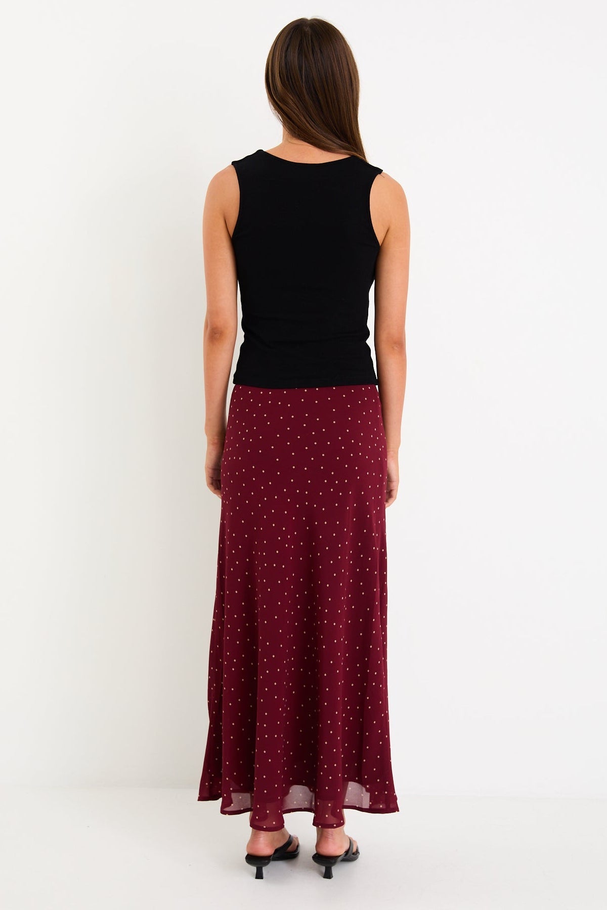 Meet your new go-to: the Emporium Skirt. Crafted in luxurious satin that moves beautifully with you, this charming piece showcases a classic polka dot print that never goes out of style. The expertly cut bias silhouette skims the body gracefully, creating an effortlessly chic look whether you're dressing it up for a night out or keeping it casual with a simple tee. Light, fluid, and endlessly versatile, the Emporium Skirt is the kind of piece you'll reach for again and again.