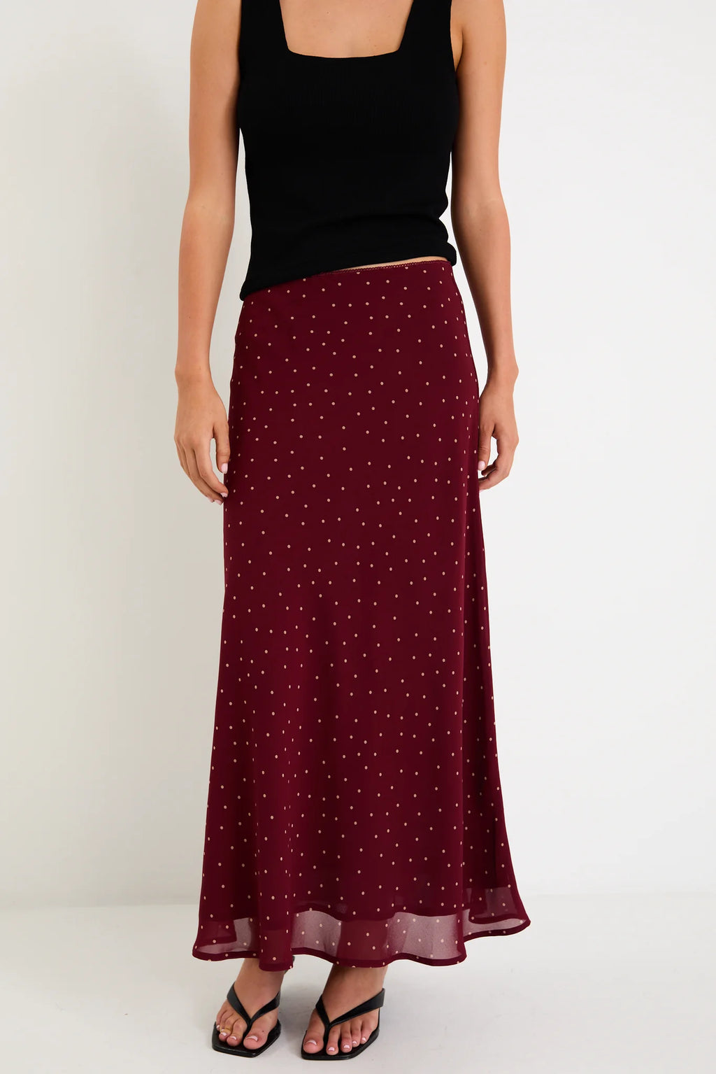 Meet your new go-to: the Emporium Skirt. Crafted in luxurious satin that moves beautifully with you, this charming piece showcases a classic polka dot print that never goes out of style. The expertly cut bias silhouette skims the body gracefully, creating an effortlessly chic look whether you're dressing it up for a night out or keeping it casual with a simple tee. Light, fluid, and endlessly versatile, the Emporium Skirt is the kind of piece you'll reach for again and again.