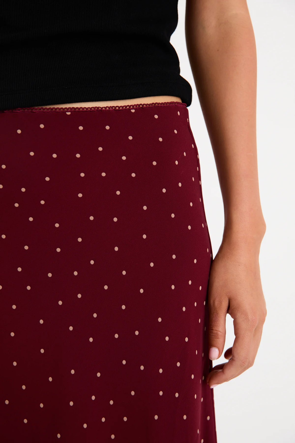 Meet your new go-to: the Emporium Skirt. Crafted in luxurious satin that moves beautifully with you, this charming piece showcases a classic polka dot print that never goes out of style. The expertly cut bias silhouette skims the body gracefully, creating an effortlessly chic look whether you're dressing it up for a night out or keeping it casual with a simple tee. Light, fluid, and endlessly versatile, the Emporium Skirt is the kind of piece you'll reach for again and again.