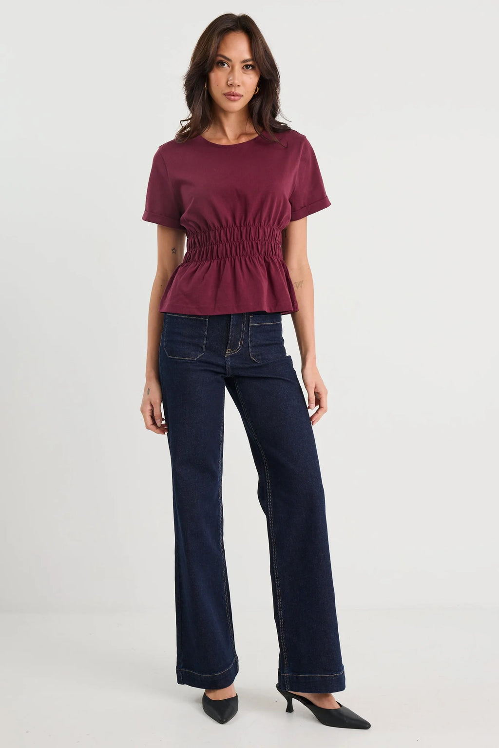 The Svelte Tee elevates the classic cotton essential with thoughtful design details. Crafted from breathable 100% cotton, this piece features a gently shirred waist that creates a flattering silhouette, paired with a softly flared hem for movement and grace. Finished with cuffed short sleeves and a refined crew neckline, it strikes the perfect balance between casual comfort and understated elegance. Versatile enough to pair with tailored trousers, flowing skirts, or your favourite denim, the Svelte Tee beco