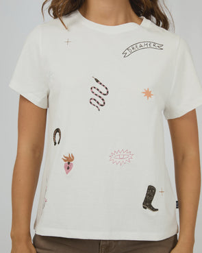 The Western Dreamer Regular Tee captures laid-back desert vibes with its crisp white fabric and playful western stamp-style prints. Its relaxed fit is perfect for tucking into denim cutoffs or layering under a slip dress, adding a subtle touch of western charm to your everyday style. Effortlessly cool and ready for any adventure!
