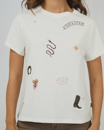 The Western Dreamer Regular Tee captures laid-back desert vibes with its crisp white fabric and playful western stamp-style prints. Its relaxed fit is perfect for tucking into denim cutoffs or layering under a slip dress, adding a subtle touch of western charm to your everyday style. Effortlessly cool and ready for any adventure!