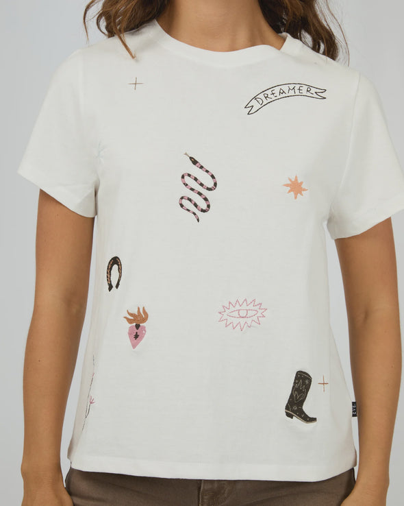 The Western Dreamer Regular Tee captures laid-back desert vibes with its crisp white fabric and playful western stamp-style prints. Its relaxed fit is perfect for tucking into denim cutoffs or layering under a slip dress, adding a subtle touch of western charm to your everyday style. Effortlessly cool and ready for any adventure!