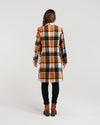 Add a pop of color to your winter wardrobe with our knee-length wool-blend coat! Its classic, elegant style is elevated by a striking orange and black plaid fabric. Perfect for the fashion-forward who still appreciate timeless sophistication.&nbsp;