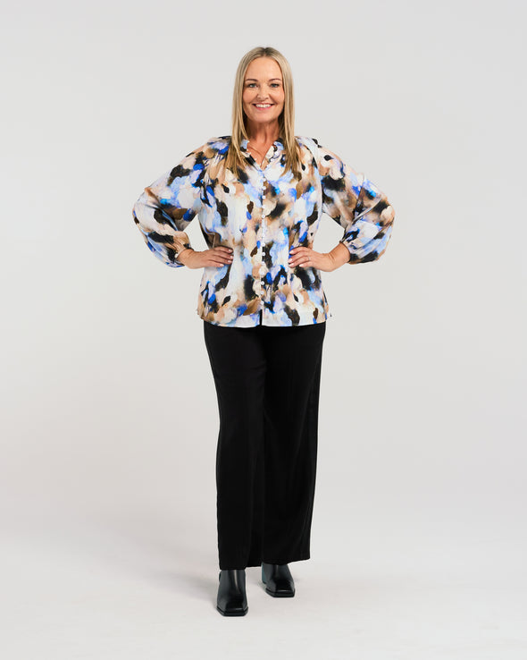 Indulge in the eye-catching appeal of our vibrant blouse. The stunning fabric boasts beautiful blue hues, while the button-down front and elasticated sleeves add a touch of chic functionality. Elevate your style with this fresh, luxurious piece.