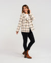 Stay stylish and warm all season in our effortlessly chic plaid coat. Made with soft fabric and shell buttons, this jacket also features convenient pockets. A must-have for any wardrobe!