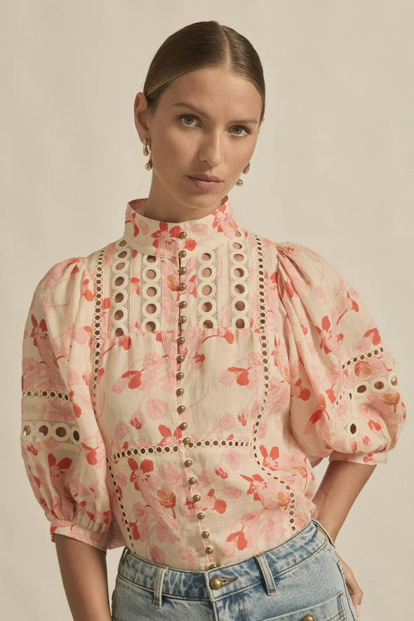 Circular lace trims and antique brass buttons bring a dash of romance to this effortlessly stylish top. The cabaret silhouette balances ornate details with everyday wearability, making it a playful favourite that adds high-impact charm without any fuss.