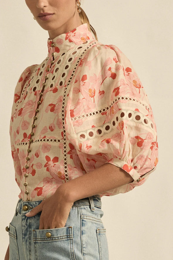 Circular lace trims and antique brass buttons bring a dash of romance to this effortlessly stylish top. The cabaret silhouette balances ornate details with everyday wearability, making it a playful favourite that adds high-impact charm without any fuss.