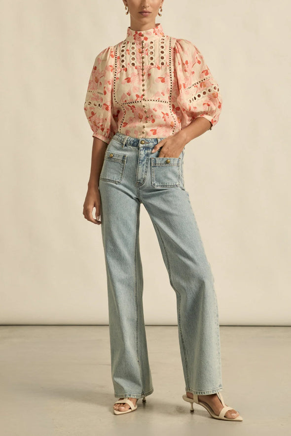 Circular lace trims and antique brass buttons bring a dash of romance to this effortlessly stylish top. The cabaret silhouette balances ornate details with everyday wearability, making it a playful favourite that adds high-impact charm without any fuss.