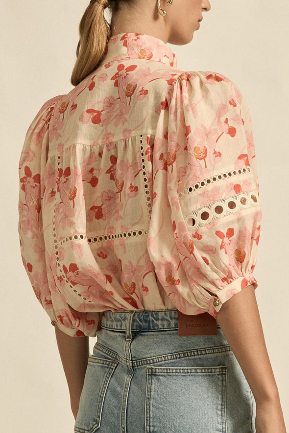 Circular lace trims and antique brass buttons bring a dash of romance to this effortlessly stylish top. The cabaret silhouette balances ornate details with everyday wearability, making it a playful favourite that adds high-impact charm without any fuss.