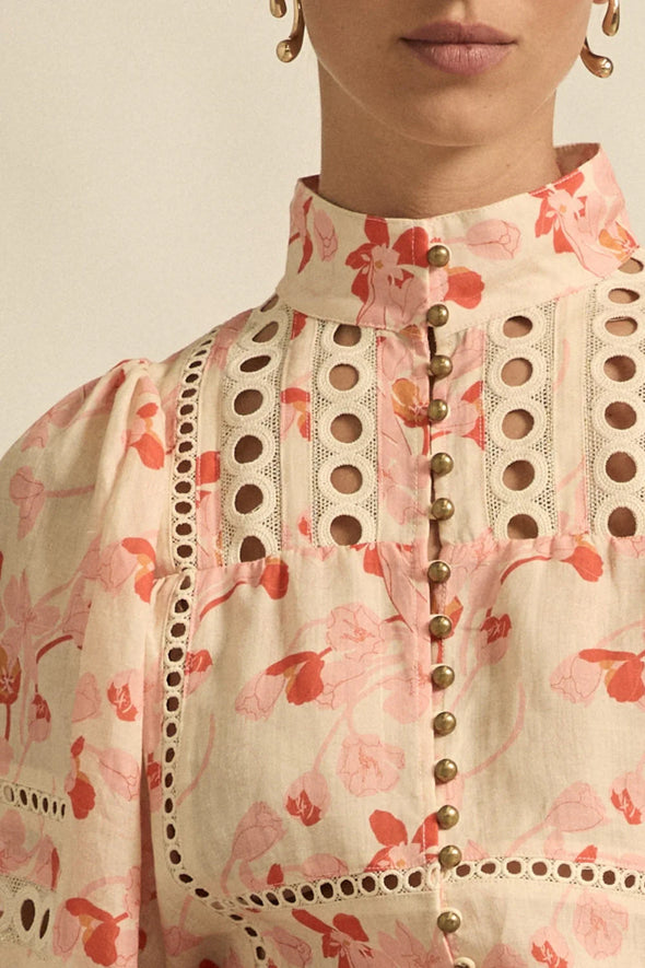 Circular lace trims and antique brass buttons bring a dash of romance to this effortlessly stylish top. The cabaret silhouette balances ornate details with everyday wearability, making it a playful favourite that adds high-impact charm without any fuss.