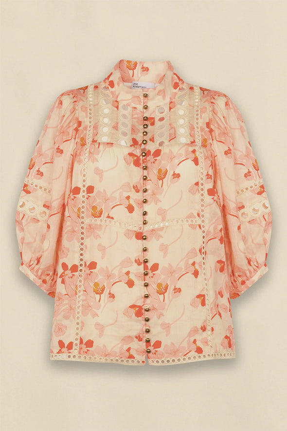 Circular lace trims and antique brass buttons bring a dash of romance to this effortlessly stylish top. The cabaret silhouette balances ornate details with everyday wearability, making it a playful favourite that adds high-impact charm without any fuss.