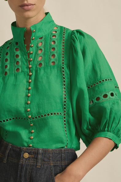 Circular lace trims and antique brass buttons bring a dash of romance to this effortlessly stylish top. The cabaret silhouette balances ornate details with everyday wearability, making it a playful favourite that adds high-impact charm without any fuss.
