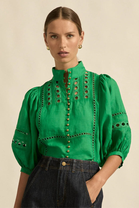 Circular lace trims and antique brass buttons bring a dash of romance to this effortlessly stylish top. The cabaret silhouette balances ornate details with everyday wearability, making it a playful favourite that adds high-impact charm without any fuss.