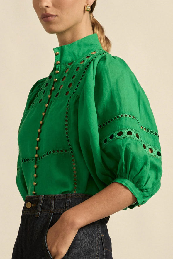 Circular lace trims and antique brass buttons bring a dash of romance to this effortlessly stylish top. The cabaret silhouette balances ornate details with everyday wearability, making it a playful favourite that adds high-impact charm without any fuss.