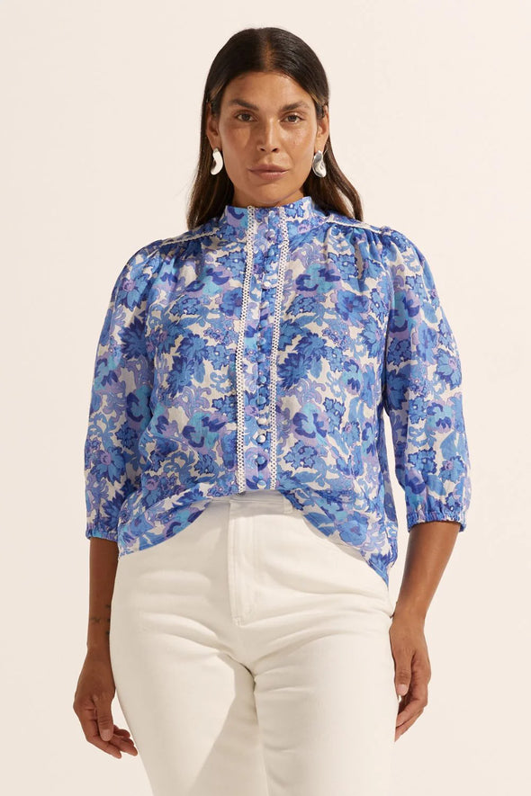 Looking for a bit of WOW factor? Then look no further. The versatile and feminine Outlook Top. Made of 100% ramie and trimmed with delicate lace, this button-down pairs perfectly with denim, tailored pants, or a simple skirt. The blouson sleeve with elasticated cuff allows for customisable styling. Elevate your off-duty, office, and event looks with this romantic piece.