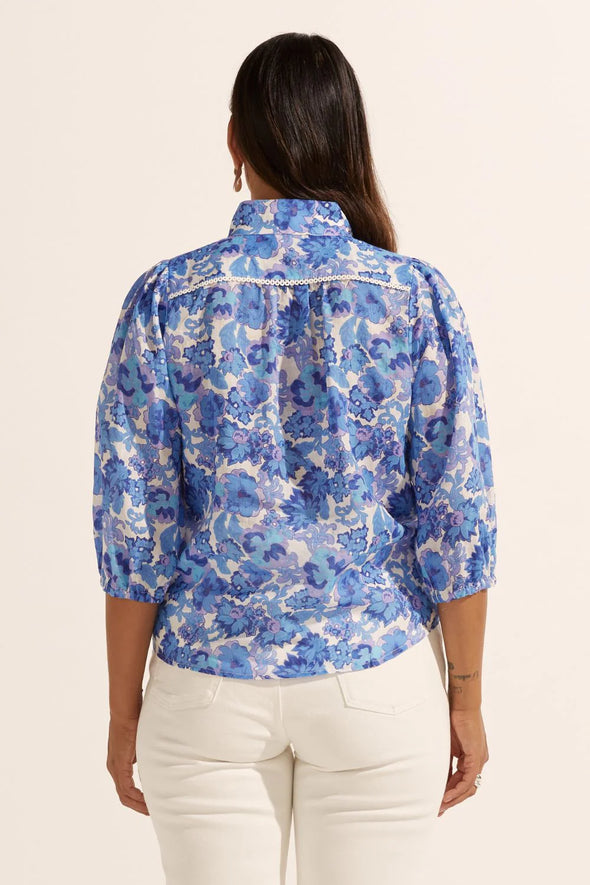 Looking for a bit of WOW factor? Then look no further. The versatile and feminine Outlook Top. Made of 100% ramie and trimmed with delicate lace, this button-down pairs perfectly with denim, tailored pants, or a simple skirt. The blouson sleeve with elasticated cuff allows for customisable styling. Elevate your off-duty, office, and event looks with this romantic piece.