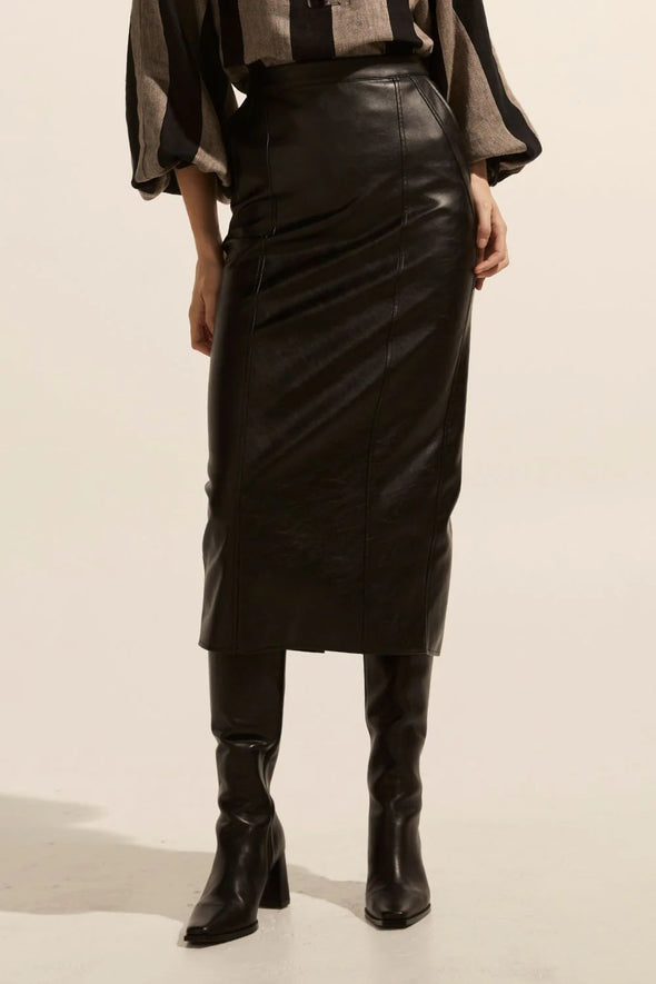 a vegan leather midi skirt, finishing mid-calf is the perfect length to pair with a knee-high boot. the tour's simple, straight-line structure nods to the classic asking to be balanced by a top with more feminine shape and movement. see product details below.