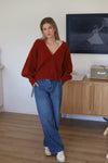 A deep v-neck, soft blouson sleeve and cropped length ensures the wander is both chic yet casual. wear this versatile knit alone as a fashion statement, or as a layering piece between seasons. see product details below. Colour Clay, a earthy red
